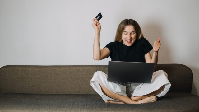 Woman Excitedly Online Shopping