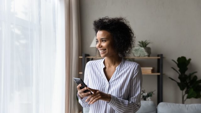 woman smiling by her window