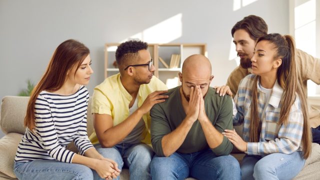Group of People Comforting a Friend