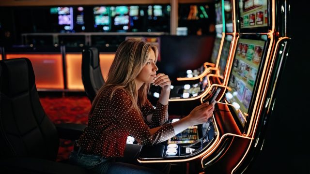 Women gambling on slot machinery