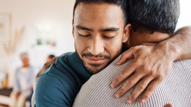 Shot of a father and son hugging at home