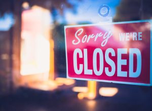 A closed sign on the front door of a business