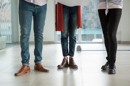 Mid adult people wearing casual clothes while standing inside building during daytime.