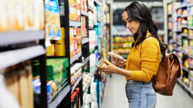 Shot of a young woman shopping for groceries in a supermarket