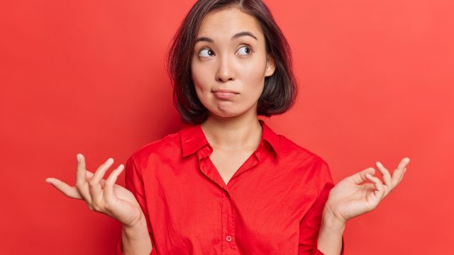 woman shrugging her shoulders - most likely to questions