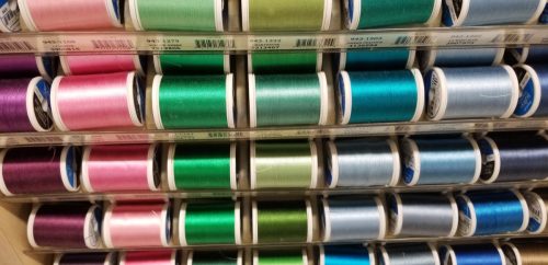 row of thread on spools