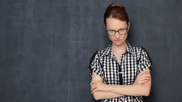 Woman with Arms Crossed and Angry Expression