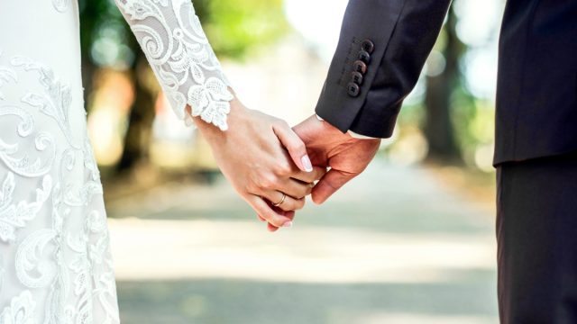 married couple holding hands