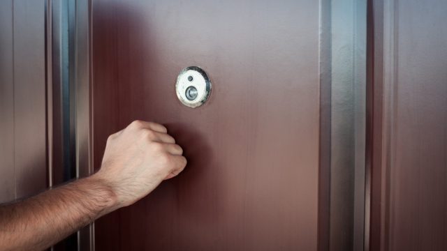 man knocking on front door