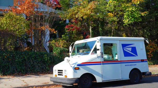 View of a delivery truck from the United States Postal Service (USPS) on the street in Bordentown, Burlington County, New Jersey, United States.