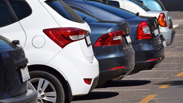 A line up of cars in a parking lot