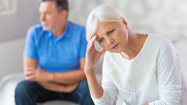 An older couple looking upset after an argument.