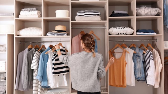 woman looking at organized closet