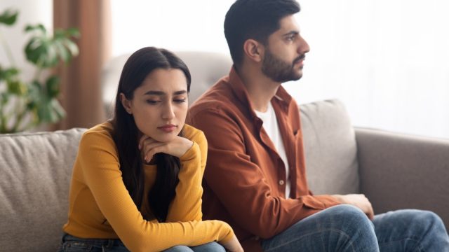 unhappy couple on couch