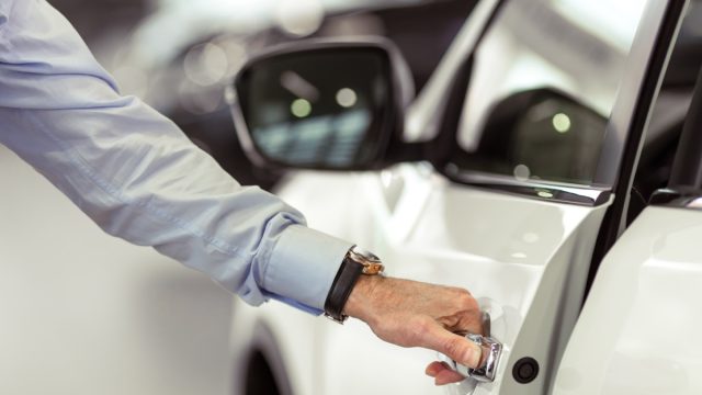 man opening car door