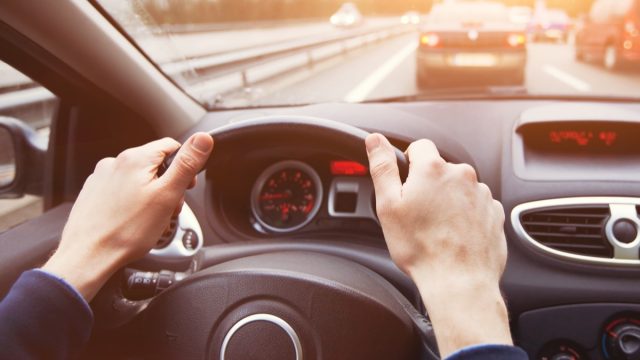 man driving down road