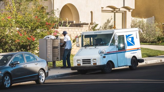 US postal worker delivering mail