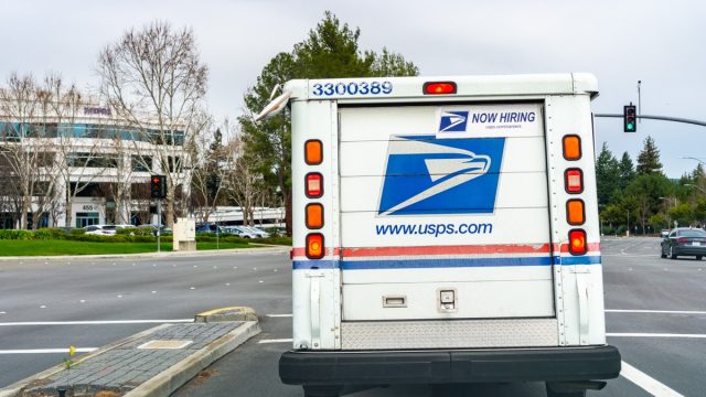 USPS vehicle driving on a busy street in south San Francisco bay area
