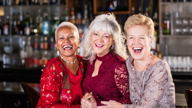 Three older women in cocktail dresses
