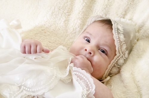 baby in christening garb 