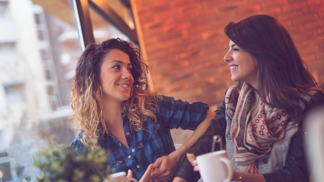 two young women having coffee at a cafe