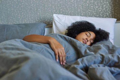 young woman sleeping in bed