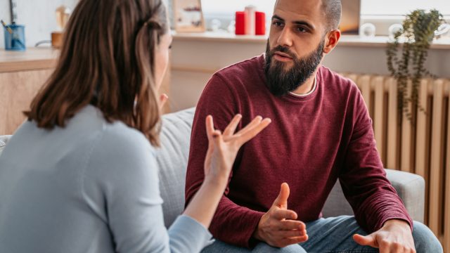 Young couple with relationship problems arguing at home.