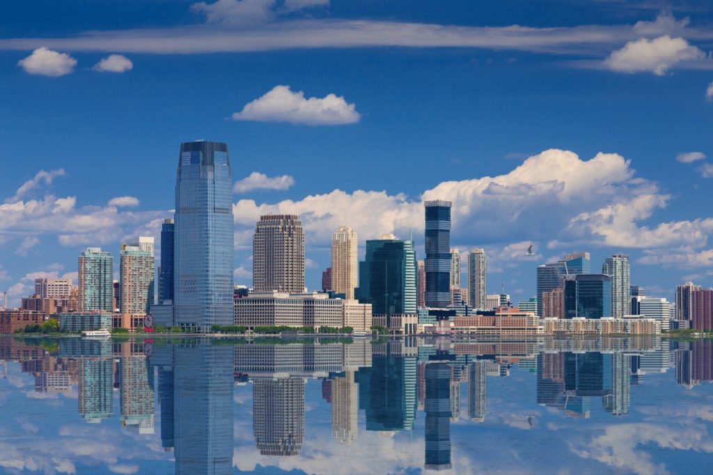 Jersey City Skyline with Goldman Sachs Tower Reflected in Water of Hudson River, as seen from Battery Park