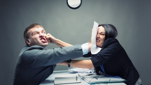 people at work exchanging unpopular opinions and fighting