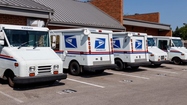 Indianapolis - Circa August 2019: USPS Post Office Mail Trucks. The Post Office is responsible for providing mail delivery IV