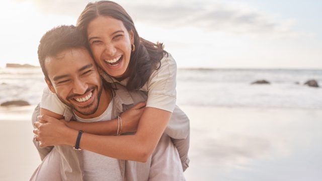 A young couple hugging on the beach