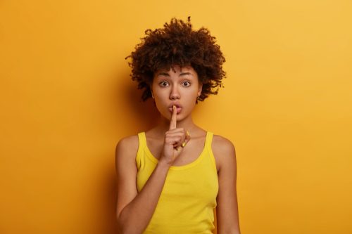 Secretive woman in yellow.