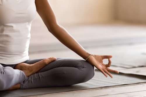 Woman meditating on a mat. 