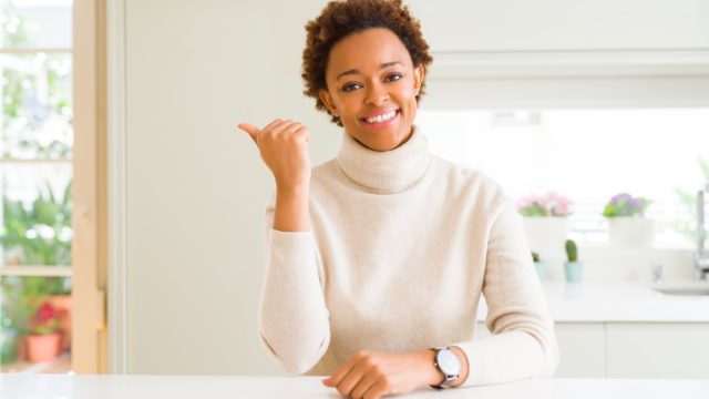 Woman wearing a turtleneck in the kitchen.