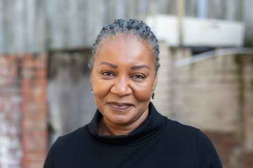 Woman wearing black turtleneck.