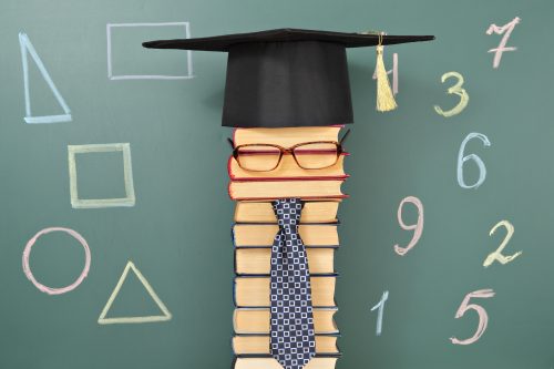 funny image - stack of books in front of a chalkboard with shapes drawn on it