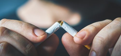 hand breaking cigarette in half