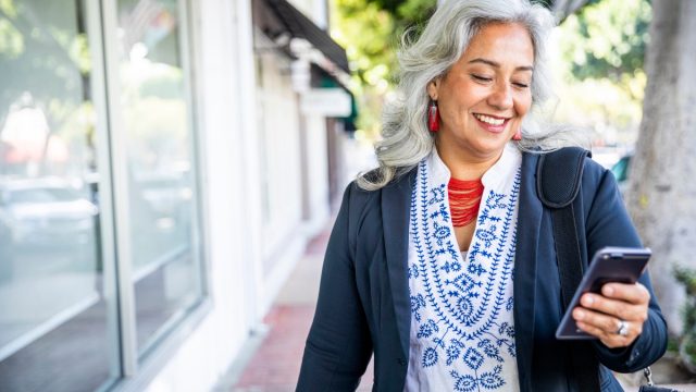 a woman texting and smiling