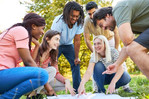 group of adults participating in a scavenger hunt outside