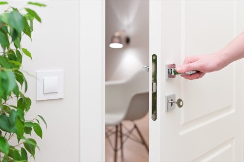 Person closing a white door.