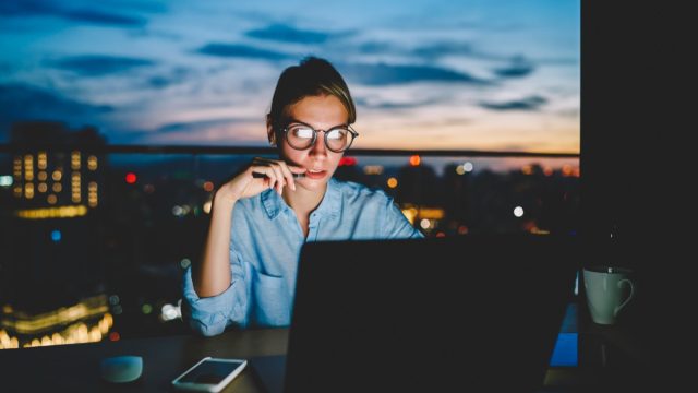 hardworking woman in office at night