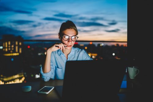 hardworking woman in office at night