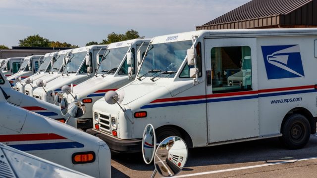 Circa August 2019: USPS Post Office Mail Trucks. The Post Office is responsible for providing mail delivery IX