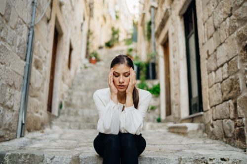 Woman outside worried and overthinking. 