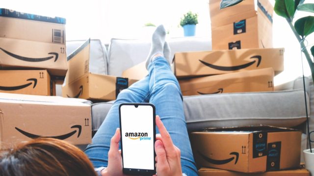 Person Surrounded by Amazon Boxes
