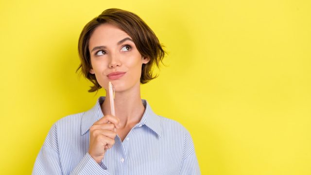 Woman Thinking with Pen to Her Chin