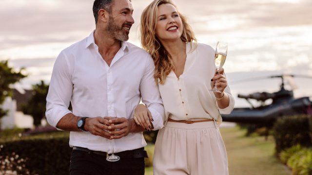 Classy couple drinking champagne outside