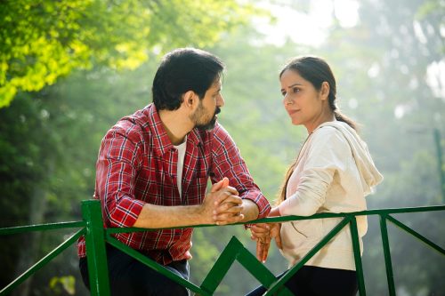 Serious couple spending leisure time at park