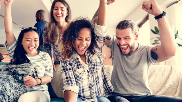 group of friends enjoying a game night with family feud questions