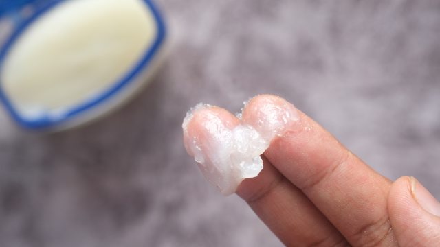 Close up of a hand using petroleum jelly